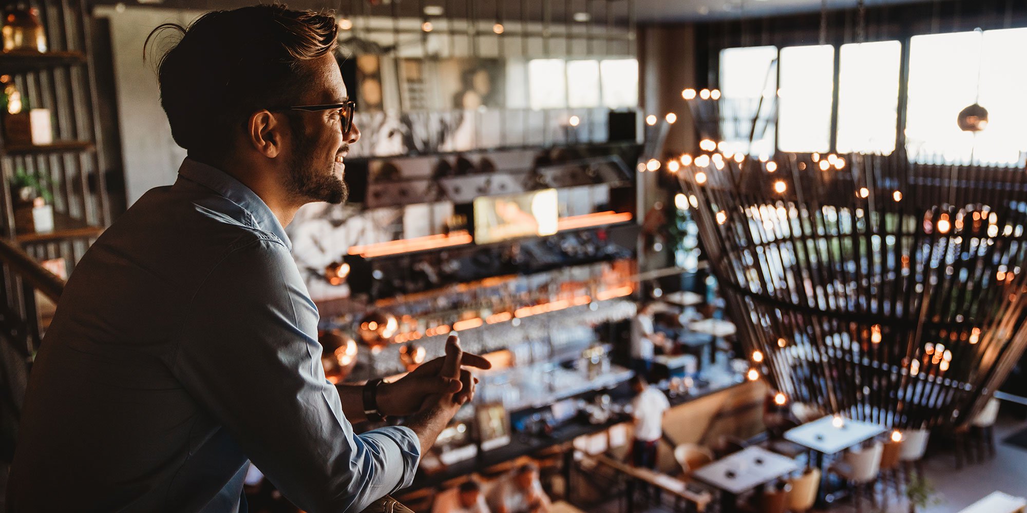 Restaurant manager overlooking modern-style dining room